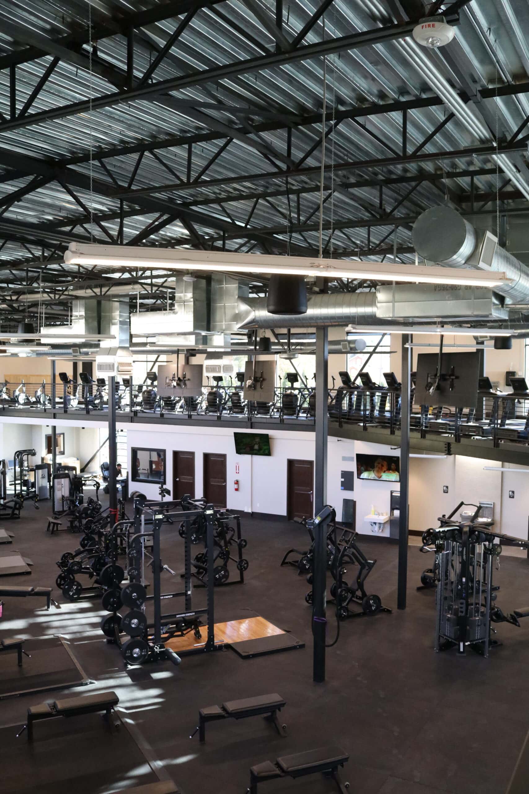 Interior of Alpine Fitness near Lehi, UT featuring modern gym equipment for personal training, strength training, cardio workouts, and weight loss training with certified personal trainers. Contact us today for help with gym in Lehi UT, gym near Lehi UT, gym near me in Lehi, fitness center in Lehi UT, local gym in Lehi Utah, best gym in Lehi UT, personal training in Lehi UT, personal trainer near me, certified personal trainer Lehi UT, one-on-one personal training near me, small group personal training Lehi UT, strength training in Lehi UT, weight training near me, cardio training gym Lehi UT, weight loss training in Lehi UT, functional fitness training near me, athletic performance programs Lehi UT, post-rehabilitation programs near me, recovery gym in Lehi UT, muscle recovery therapy near me, cold plunge therapy Lehi UT, massage therapy near me, nutrition consulting in Lehi UT, gym with modern equipment near me, clean gym Lehi UT, gym with personal trainers near me, small group training programs Lehi UT, strength & conditioning programs near me, functional fitness programs in Lehi UT, athletic performance training near me, post-rehab & recovery programs Lehi UT, personalized fitness programs near me, gym with recovery services near me.